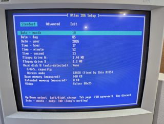 A blue Atlas 286 Setup screen on a CRT, listing date, time, floppy drives A: 1.44 MB and B: 1.2 MB, hard disk, memory and video